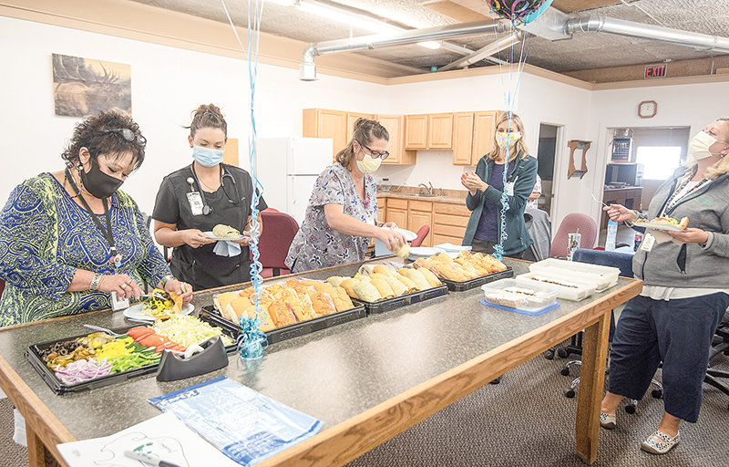 Staff at Heritage Health Center observe its fifth anniversary in Powell with celebratory balloons and a luncheon buffet on Thursday. Around the table are (from left) Lydia Hernandez, Amanda Buffkin, Tolyn Brewer, CEO Colette Mild and Heather Bales.
