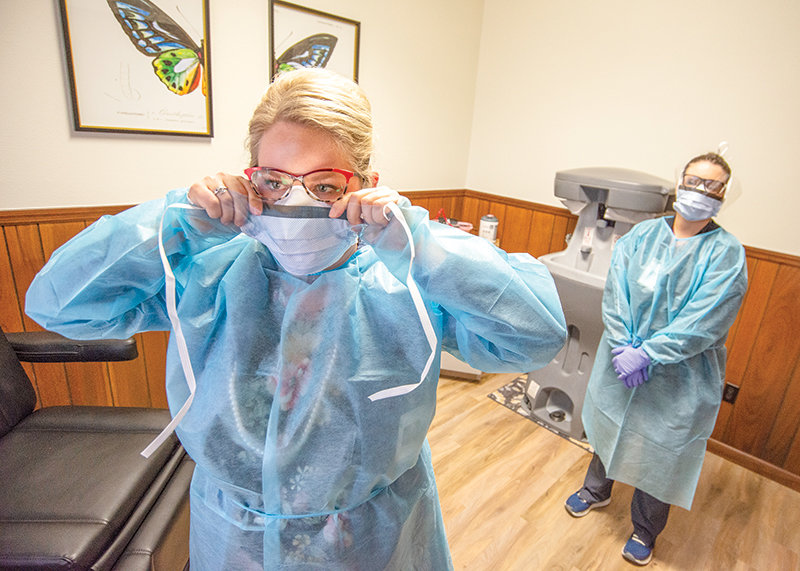 Sarah Sowerwine, who recently took over Heritage Health Care’s chief medical officer position, puts on a mask in the nearly completed viral care portion of the healthcare facility.