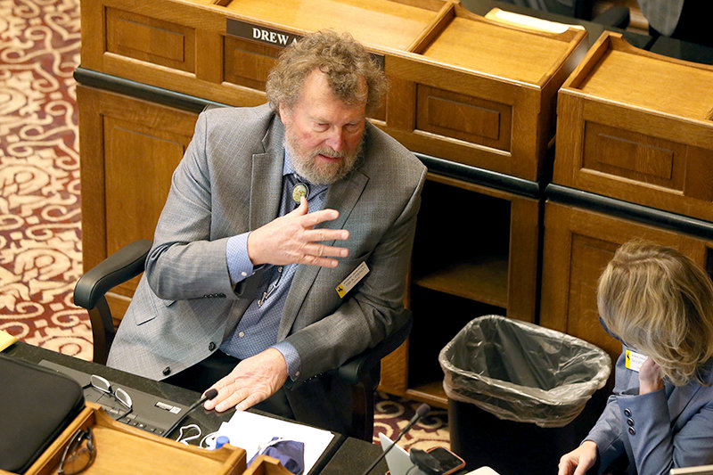 State Sen. Tim French, R-Powell, visits with Sen. Tara Nethercott, R-Cheyenne, during Tuesday’s opening day of the 2021 General Session. French was known for more casual attire during his time on the Park County Commission, but the Legislature requires a suit and tie. Lawmakers met only briefly before adjourning for virtual work later this month.