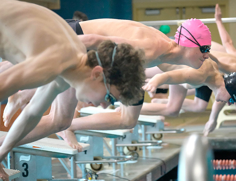 Panther swimmer Ashtin Prentiss (pink cap) leaps from the starting blocks at a recent meet in Worland. Competing in Buffalo Friday, Prentiss grabbed a state-qualifying time in the 200 individual medley and finished the event third overall. The Panthers’ next action is the 3A West Conference Championship Saturday in Lander.