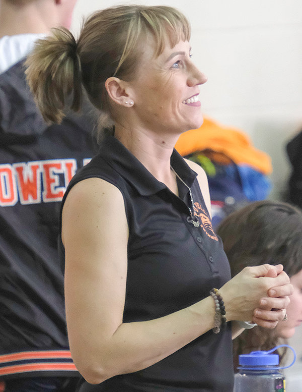Stephanie Warren watches on as her team competes at a meet. The coach noted her faith, as well as the people in her life, as motivation to persevere through her battle.
