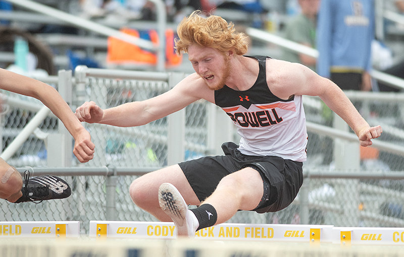Eli Weimer clears a hurdle Friday in the 110 hurdles. In addition to placing fourth in that event, he won the high jump.