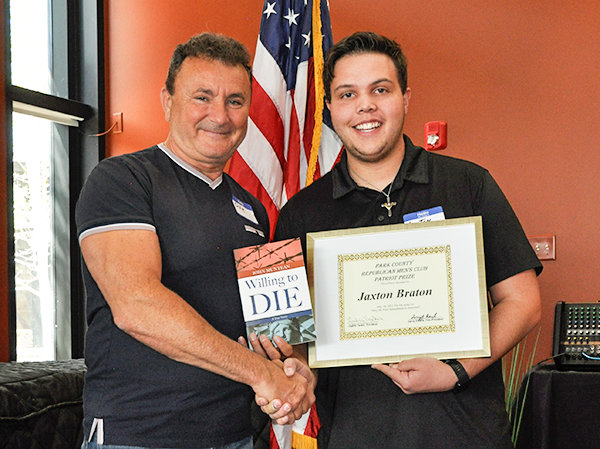 After taking third place in the Park County Republican Men’s Club’s essay contest, Jaxton Braten poses with his certificate and author/speaker Ovie Muntean on Sunday, May 16. Braten won $200.