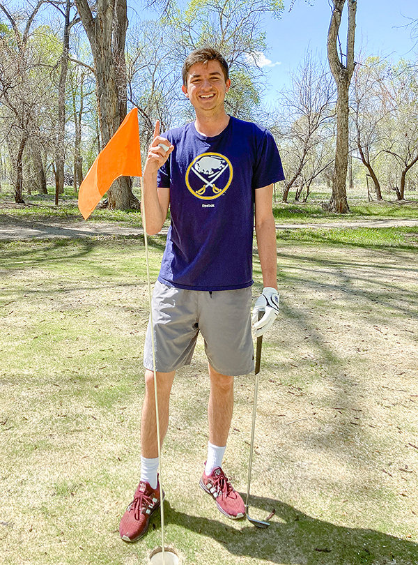 Tribune Sports Reporter Carson Field poses by the flagstick at hole 5 of Chapel Lane Links on May 16 after hitting a hole in one. The ace was Field’s first.