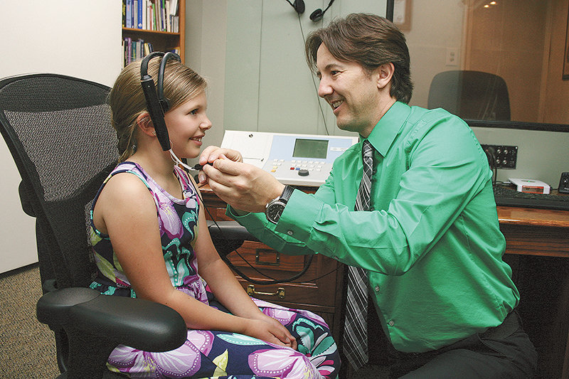 Dr. Levi Asay checks Amethyst Hartley during a hearing test at his office at Bighorn Basin Hearing and Speech in Cody. While hearing loss is most likely to occur between the ages of 60-74, hearing loss in children can be devastating in the learning process of children.