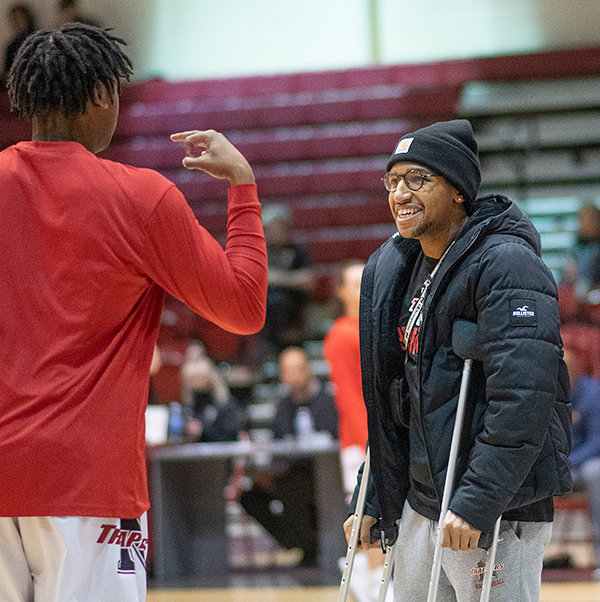 Alan Swenson (right) talks with Jerome Mabry before a Northwest College men’s basketball game. Swenson started the year as NWC’s starting point guard before tearing his achilles. He is slated to return to the team next year.