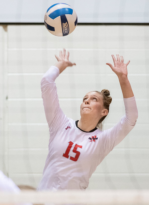Kiah Johnson serves for the Trappers in a volleyball match. After fracturing her femur and tearing her ACL and meniscus, Johnson returned to her hometown of Morgan, Utah.