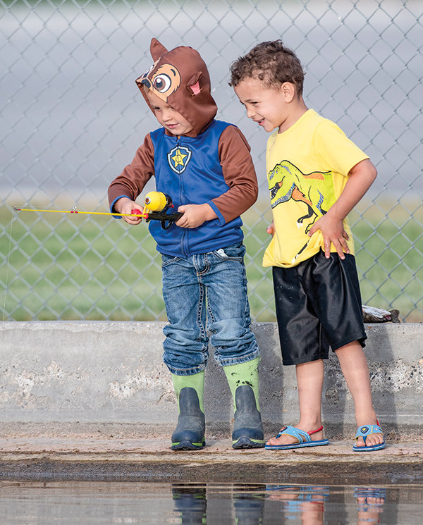 Rhylee Goolsbey (left) and his best buddy Gabriel Craig, both 4 years old, fish during the free fishing day at Homesteader Park Saturday. Rhylee’s brother, Rowdy, caught the first fish of the derby.