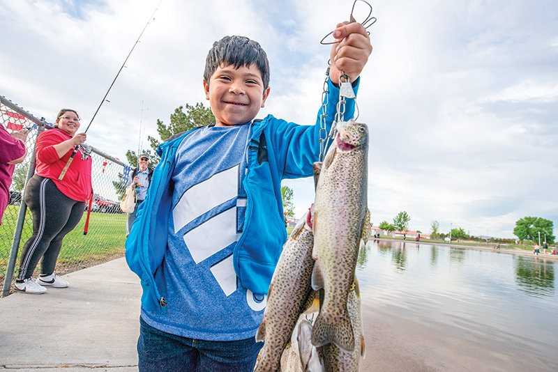 Javier Salazar shows off his family’s string of trout at the end of their hour of fishing in the derby. Javier celebrated his 6th birthday at the event.