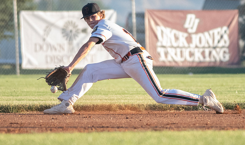 Pioneers shortstop Brock Johnson stretches for a ground ball against the Lovell Mustangs on Monday. Powell enters Thursday 25-5, with the team set to face Cody at home.