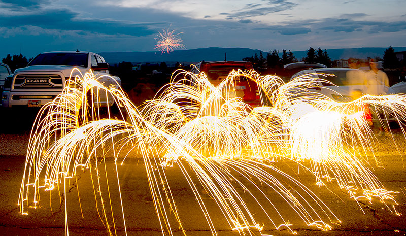 A sparkler becomes twirling lines of light in this long exposure photograph, taken at an Independence Day celebration in Cowley, sponsored by S&L Industrial. The event also featured ice cream, music and more.