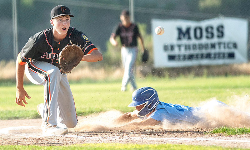 Pioneers third baseman Cade Queen attempts to tag a stealing runner out against Cody Tuesday. The Cubs again got the better of the Powell squad, sweeping the doubleheader at Mildward Simpson Field.