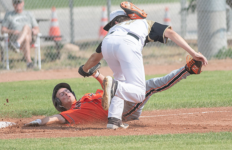 Landon Sessions tries to avoid a tag at third base against Buffalo in Powell’s first game of the district tournament on Friday. Powell beat Buffalo 19-7.