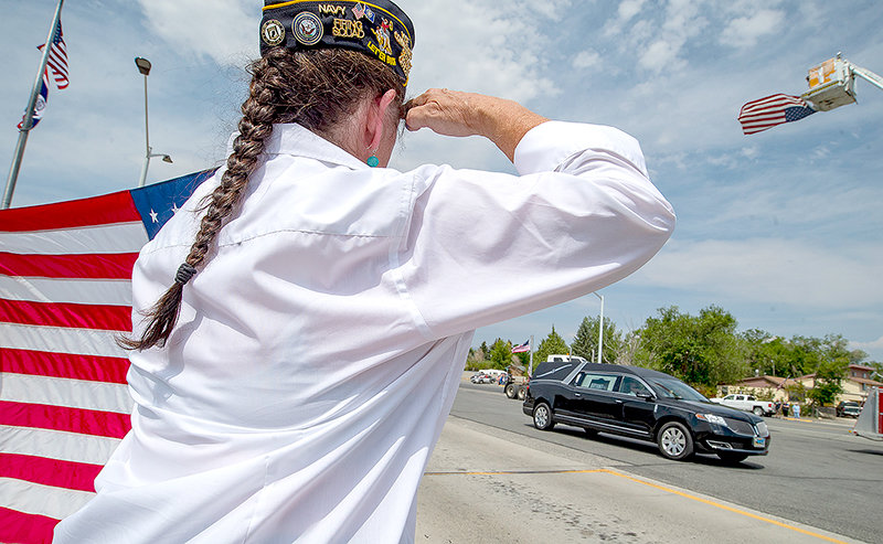 Katy Jones, vice commander of American Legion Post 26, salutes as the hearse carrying Worland native and Vietnam veteran Alva R. Krogman passed through Frannie Monday. After being shot down over Laos in 1967, Krogman’s remains were returned to Worland and his final resting place this week.