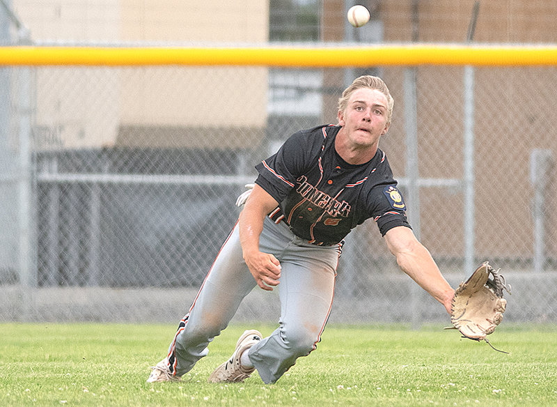 Outfielder Kobe Ostermiller dives for a ball in the Powell Pioneers’ doubleheader against Cody on July 2. Powell enters this week’s state tournament as the No. 3 seed from the West District.