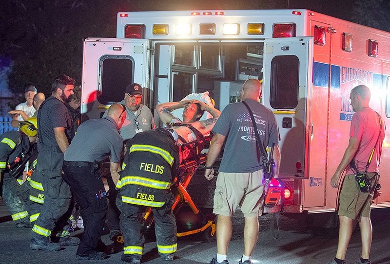Personnel from Powell Valley Healthcare and the Powell Volunteer Fire Department load Michael Levario into an ambulance after he crashed and passed out on Avenue E. He’s facing a DUI charge in connection with the incident.