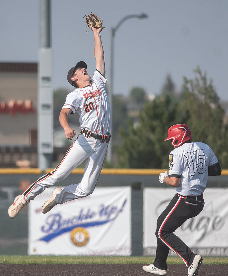 Trey Stenerson leaps for a ball as Lovell’s Tyson Christiansen steals second in Monday’s game. The Pioneers finished the season 31-12, their best finish in several years.