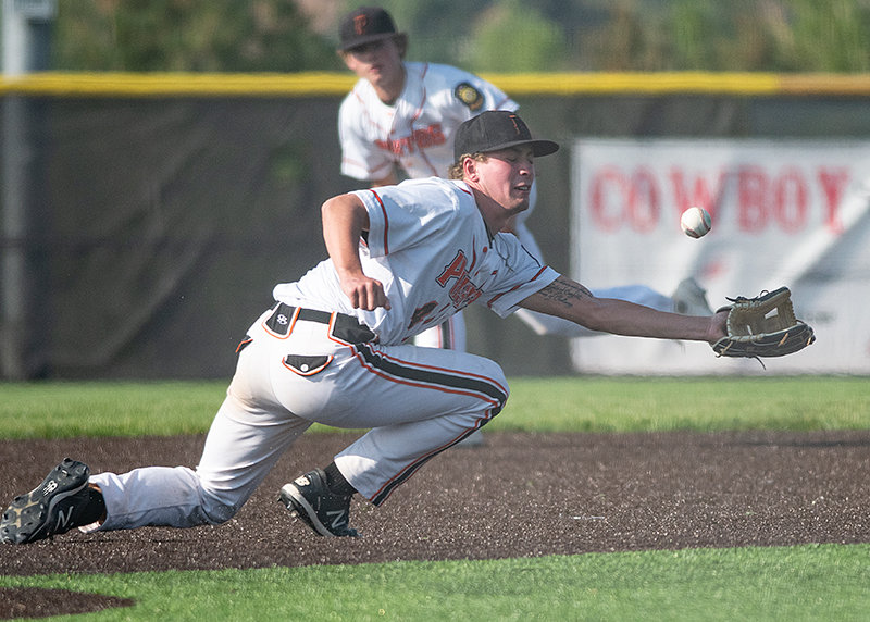 Mason Marchant dives for a ball at third base against the Mustangs.