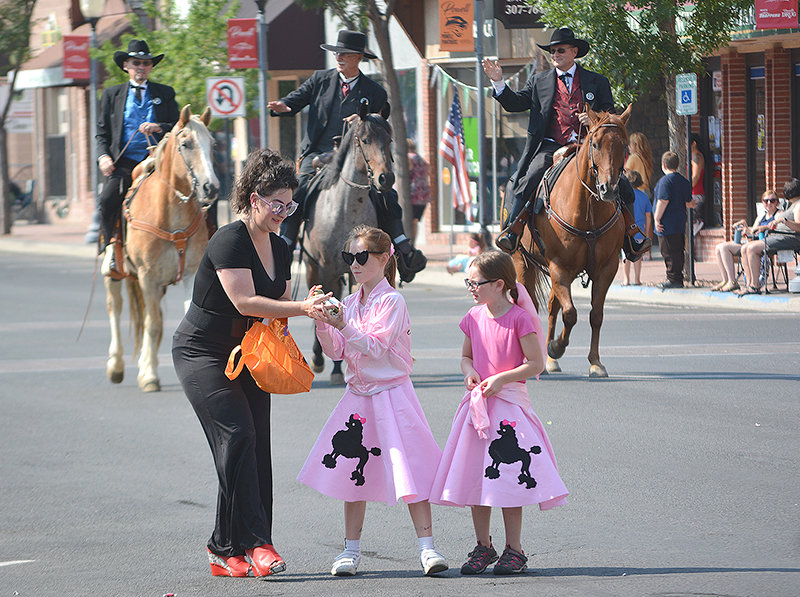From left, Trish Moulton, Zaphira Paul and Solana Moulton prepare to hand out goodies along the fair parade route Saturday morning. Young spectators had ample opportunities to grab candy and swag during the annual parade, which was sponsored this year by Dano Youth Camp.