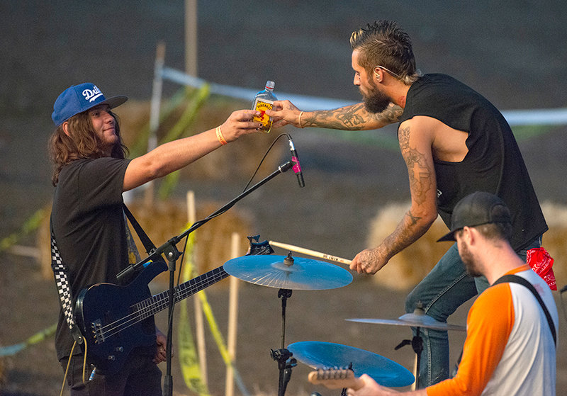 Sam Cox Band members Josh Searan and Dillon Escue share a bottle of Fireball Cinnamon Whisky during their Thursday performance at the Park County Fair. Fair leaders chose a less expensive act for this year’s concert and ‘we suffered the consequences of that,’ said Park County Buildings and Grounds Superintendent Mike Garza.