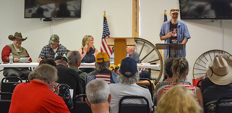 Members of the Park County Republican Party Central Committee applaud as precinct committeeman Troy Bray finishes reading a letter reprimanding U.S. Rep. Liz Cheney, R-Wyo. The party overwhelming approved a letter that tells Cheney she is ‘fired’ as their Republican representative.