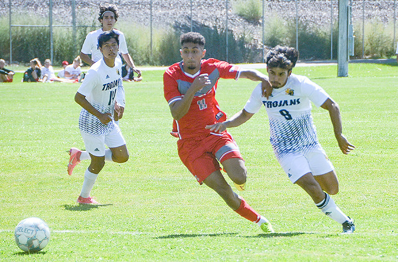 Trapper defender Aimane Sahraoui attempts to hold off Trinidad attacker Rafael Hishimoto Friday en route to a 1-1 draw in Alamosa, Colorado.