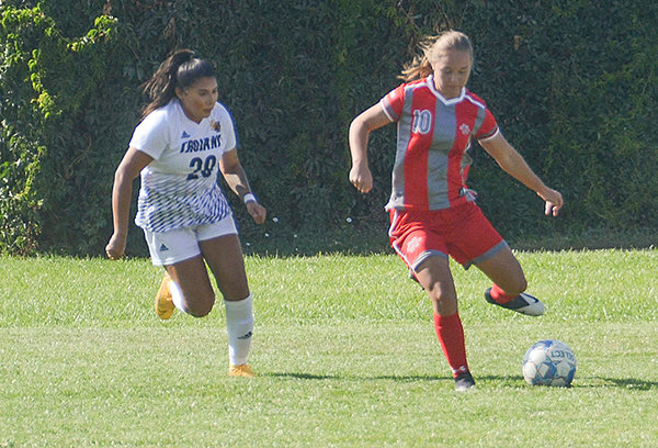 Trapper defender Kylie Dellinger looks to transition the ball into midfield in Friday’s game; the NWC defense earned a shutout against Trinidad.
