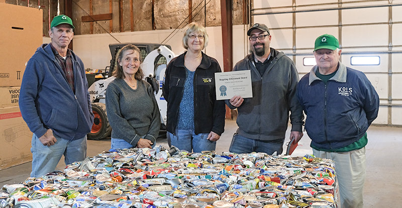 Beau Peck, with Interwest Paper, holds up the award the company granted to Powell Valley Recycling. With Peck, from left, are the facility’s shop manager, Robert Taylor, and PVR board members, Gretchen Beerline, Marynell Oechsner, and Myron Heny.