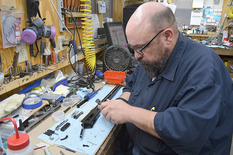 Aaron Lynch works on a firearm earlier this month at Big Horn Armory, a Cody business that builds big bore lever guns and semi-automatic rifles. Big Horn Armory has been unable to list its firearms for sale on ShopWyoming.com, due to restrictions from the payment processors integrated with the underlying ecommerce platform.
