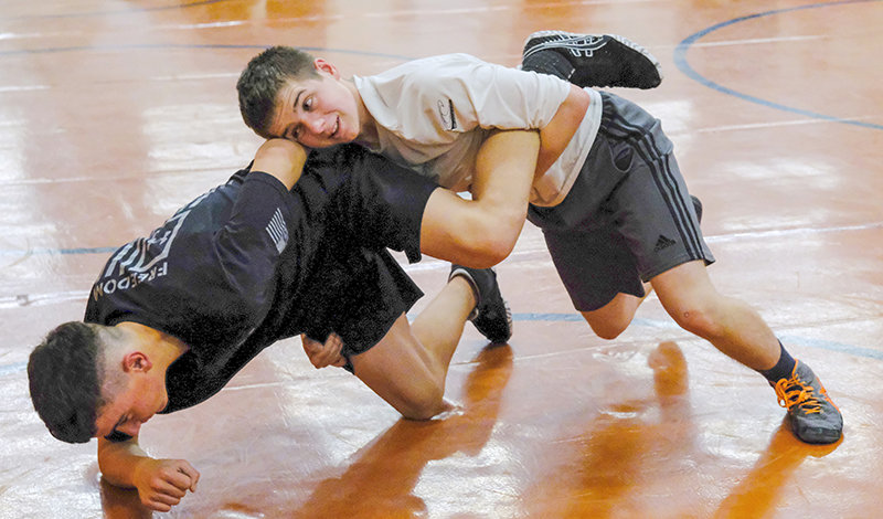 Patrick Haney (left) and Sam Childers (right) work on a takedown drill as the Panthers begin a practice before the Thanksgiving break. Childers brings varsity experience to a young Panther roster that returns only one placer from last year’s state tournament team.