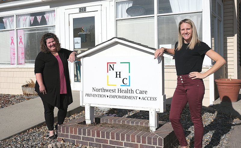 Northwest Health Care Executive Director Michelle Gutierrez and Board President Lindsay Ruble stand in front of the facility’s new sign. The provider has always been a source of affordable care for reproductive health. Now they are expanding their low-cost services to minor health care needs as well.