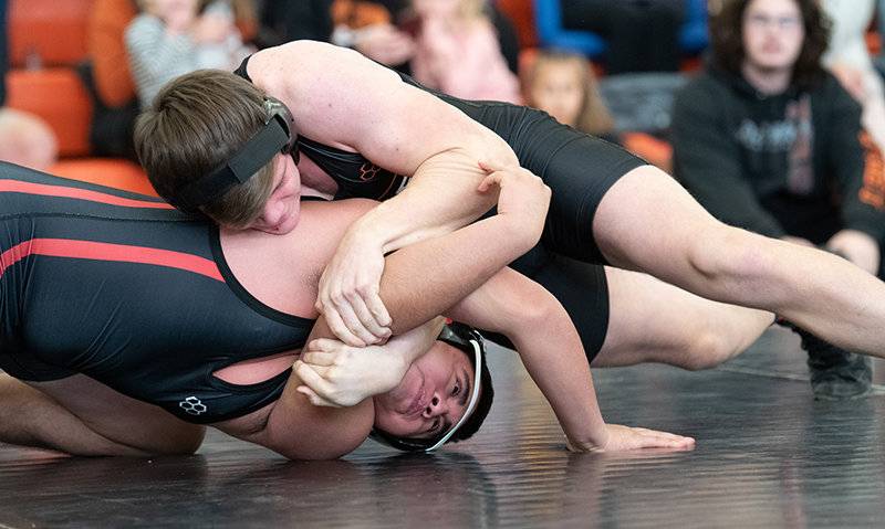PHS sophomore Jimmy Dees goes for the pin against Riverside’s Bryan Galvez during his opening match of the Powell Invitational. Dees lost just one match all weekend, taking third in the 195-pound division.