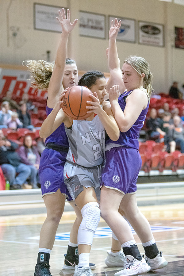NWC freshman Nayeli Acosta is double teamed by Carroll College JV defenders during their contest on Friday. Acosta and the Trappers put up some of their best shooting performances of the season in their first home contests of the year, after a month on the road.