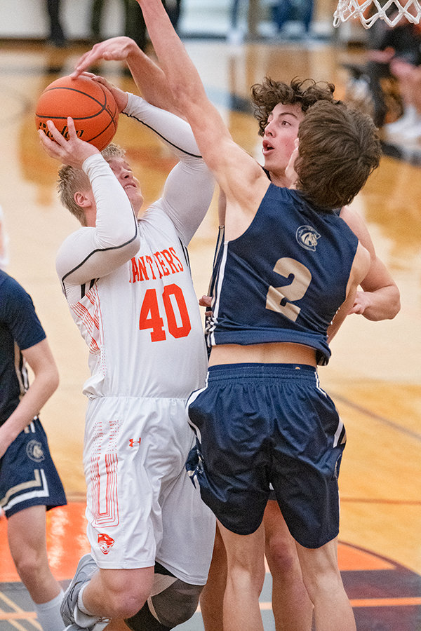 PHS senior Toran Graham fights against two Bronc defenders as he looks to finish at the rim during the Panthers’ Thursday contest against Cody. Graham scored 18 points and grabbed 13 rebounds, but the Panthers dropped the close contest, 53-49.
