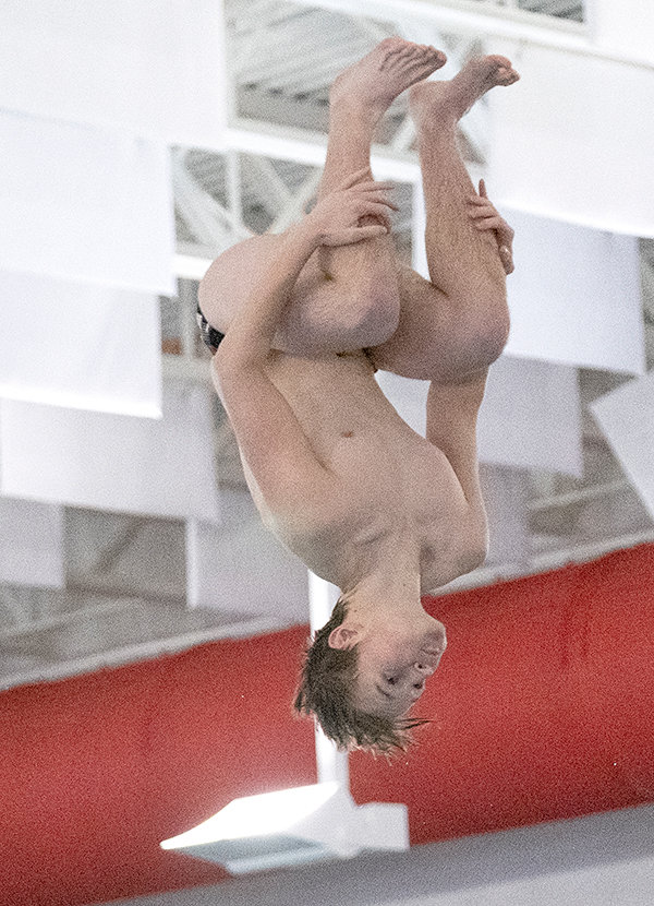 PHS sophomore Jon Hawley keeps his knees tucked during his opening round dive of the Gene Dozah Invitational. Hawley and his fellow divers continued their strong early season success during their final two home meets on Friday and Saturday.