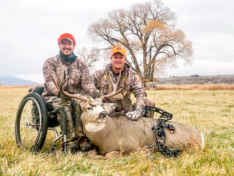 Dan Jordan and his hunting mentor from Wyoming Disabled Hunters, Scott Smith, pose with Jordan’s mule deer buck after a successful hunt last fall. The group is now accepting applications for the 2022 season — and looking for volunteers to help out with hunts.