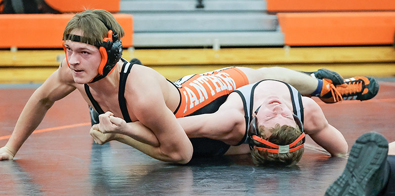 PHS junior Vinny Timmons holds down Huntley Project’s Hayden Ramaeker as he tries to finish off Tuesday’s match. Timmons pinned Ramaeker in the first period at the 1:22 mark, but the Panthers dropped the matchup to Huntley Project 59-21.