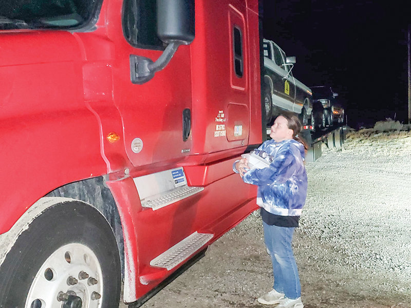 A volunteer delivers food to truckers stranded in Rock Springs on Jan. 6. A team of volunteers organized by Joey Majko makes it a point to deliver hot food to truckers when they are unable to travel because of bad weather.
