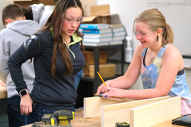 PHS sophomore Kylee Terry (left) and freshman Constance Beauchamp-Johnson work to assemble their project in the Intro to Woods class.