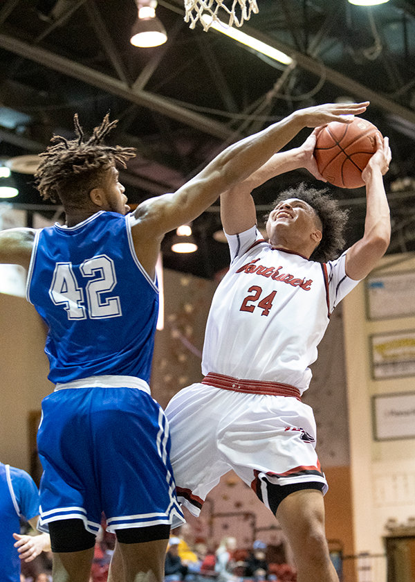 NWC freshman Bryson Stephens goes up strong in the paint against a Miles Community College defender. Poor shooting and a late game collapse saw the Trappers drop their final non-region game.