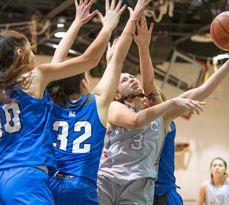 NWC sophomore Celina Tress puts up a shot with her left hand as she is swarmed by Pioneer defenders during their contest on Saturday. Tress and the Trappers’ strong second half push propelled them to a fourth straight victory.