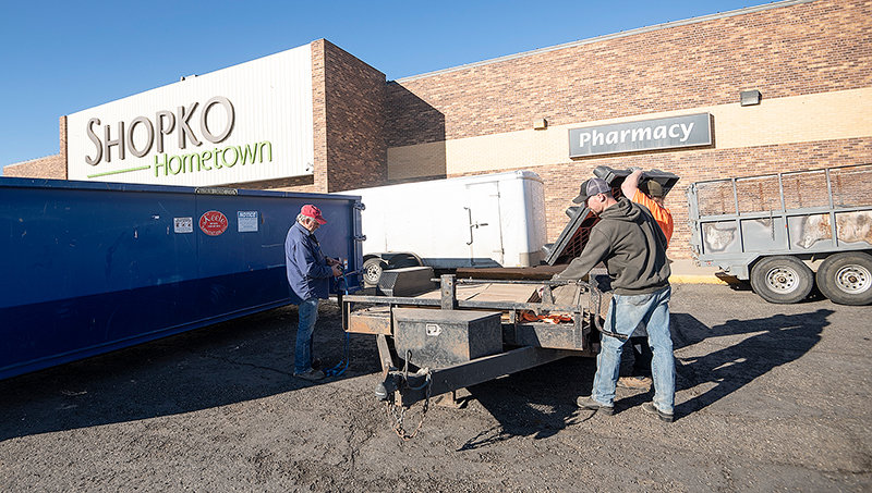 From left, Tom Hammons, Ryley Bosch and Brad Pearson of Ingraham Environmental Inc., unload supplies in front of the former Shopko building — now owned by Albertsons LLC — on Wednesday afternoon. The company is renovating the building for the future grocery store.