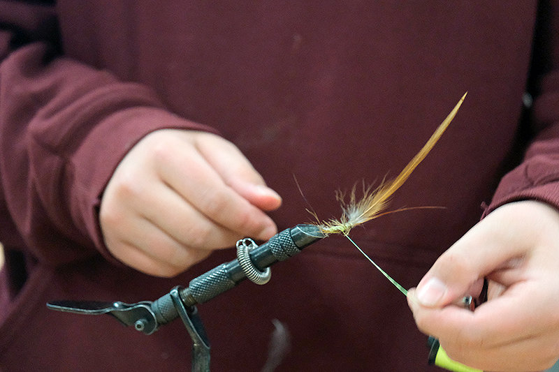 Jace Lejeune puts the finishing touches on his fly.