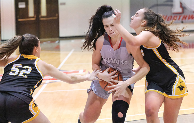 NWC sophomore Celina Tress drives into the lane as two Eastern Wyoming defenders collapse on her. Tress and the Trappers will head on the road to Western Wyoming before returning home next Wednesday at 5:30 p.m. to take on Central Wyoming.