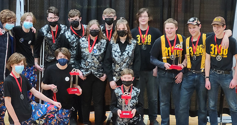 Members of team Squiggle Splat Bang pose with their trophy after wining Idaho State Robotics. The team (from left in 3188 shirts) is made up of Jacob Harms, Isaac Stensing, David Polson and Daniel Merritt.