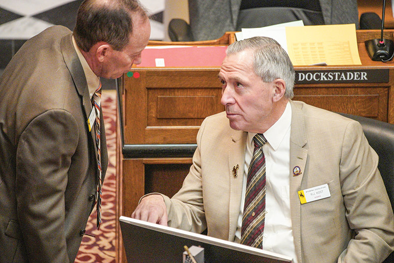 State Sen. R.J. Kost, R-Powell, visits with Sen. Bill Landen, R-Casper, during the Legislature’s recently concluded Budget Session. Landen says the redistricting plan ultimately passed by the body — which will add two representatives and one senator — fixed many problem areas.