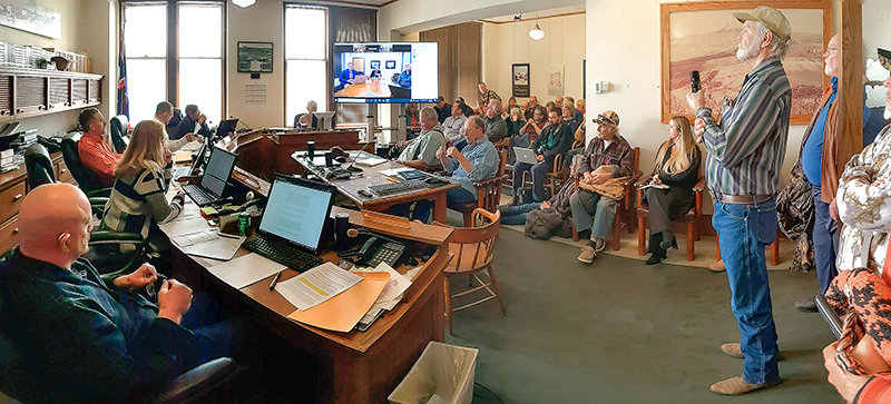 Park County commissioners and members of the public listen to Wyoming Secretary of State Ed Buchanan (appearing on screen) Tuesday while discussing a request to allow a group of volunteers to hand count the results of August’s primary election. Commissioners delayed a decision after Buchanan suggested that a hand count could run afoul of state law.