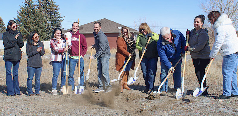 From left, Abby Neihart, Kaci Sessions, Shianne Gifford, Heilas Gifford, Nathan Gifford, Heath Streeter, Amy Wells, Janet Spiering, Tom Spiering, Nikki Hutzenbieler and Paulette Bagnell participate in a March 11 groundbreaking ceremony for a new Mountain Spirit Habitat for Humanity home in Cody. The ceremony signified the beginning of the new home build.