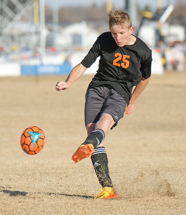 Ethan Frame tries a long distance shot in the first half against Worland on Thursday, April 7.