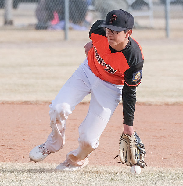 Jordan Loera reaches down with his glove to stop a short hit by the Lovell Mustangs on Saturday. The Pioneers dropped both games 15-2 and 8-7,  starting conference play 0-2.